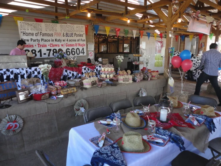 Decorated tables and benches inside the party barn